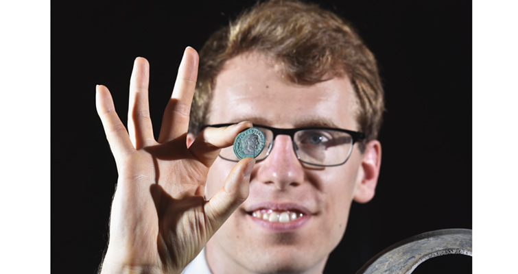 curator-with-a-coin-from-the-hoard