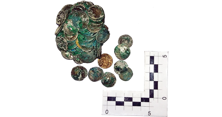 pile-of-coins-with-ruler-for-scale